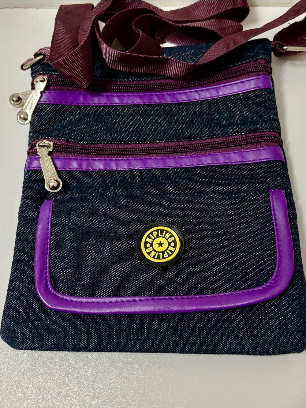 Kipling Denim Crossbody Bag with Purple Trim and Maroon Strap